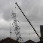 Rainham, UK: Following a fire at its base in June 2003, this pylon was teetering at 45 degrees until its removal. [Picture by Lochii]