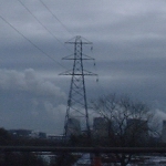 M1, UK: Pylon carrying wires on only one side to the power station in the background, on the route between London and St Albans [Picture by Flash Wilson]